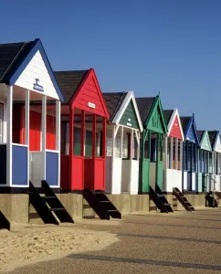 Prints of BEACH HUTS, Southwold, Suffolk. Row of eight colourful beach huts Explore England - Iconic Landmarks and Places to Visit: Colourful Southwold Beach Huts Print