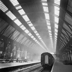 Prints of KINGS CROSS STATION, London. Interior view of the train shed at Kings Cross Station showing a train standing beside an almost empty platform. Photographed by John Gay. Date range: 1960-1972 Transport Prints: Print of Kings Cross Station interior, showing a train on an empty platform