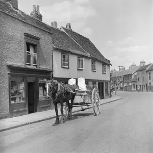 Prints of BURY ST EDMUNDS, Suffolk. Some commodities were still delivered using a horse and cart in the post-war years Suffolk Prints: Horse-drawn milk float in Bury St Edmunds, Suffolk Print