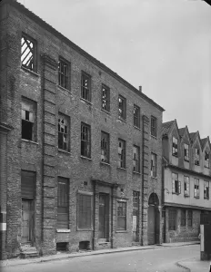 Prints of Norfolk Iron Works, Coslany Street, Norwich. The front elevation of 24 Coslany Street showing bomb damage, with number 22 visible in the background Historic Photos of England - People, Places and Everyday Life: Print of Norfolk Iron Works, Norwich, 1942
