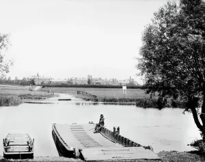 Prints of CHOLSEY, Oxfordshire. The low flat ferry boat awaits the corn wagons that used to cross the River Thames at this point Berkshire Prints: Print of a low flat ferry boat on the River Thames, Cholsey, Oxfordshire