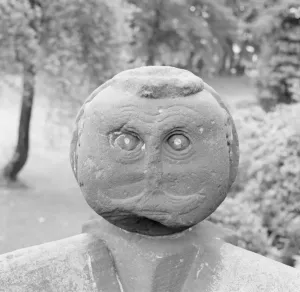 Eric De Mare Prints: Print of a Victorian stone head on a garden wall