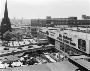 Prints of BULL RING CENTRE, BULL RING, BIRMINGHAM, WEST MIDLANDS. A general view of the Bull Ring Centre showing the busy open market and Union Jack flags for the Queens Silver Jubilee Birmingham Prints: Bull Ring Centre Print, Birmingham, 1977