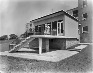 Prints of West Cumberland Hospital, Homewood Road, Homewood, Whitehaven, Copeland, Cumbria. Two nurses outside the entrance to the nurses accommodation block at West Cumberland Hospital Cumberland Prints: Print of Nurses Accommodation at West Cumberland Hospital