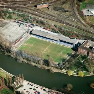 Prints of GAY MEADOW, Shrewsbury. Former home of Shrewsbury Town Football Club, vacated in 2007. The Shrews were famous for employing a coracle to retrieve lost balls from the River Severn Sport Prints: Print of Gay Meadow, a former football ground in Shrewsbury