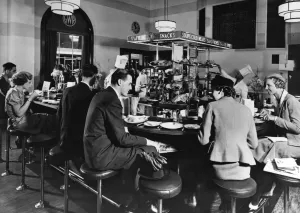 Prints of An interior view of Paddington station showing a busy snack bar, which probably opened soon after the modernisation of the station in the 1930s Stations And Halt Prints: Paddington Station Quick Lunch Print, 1936