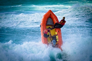 Lifeguards on an arancia inshore rescue boat in the surf at Perranporth beach, Cornwall Lifeguards on an arancia inshore rescue boat in the surf at Perranporth beach, Cornwall