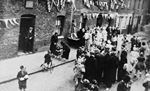 Aerial view, people at a street party with bunting Aerial view, people at a street party with bunting