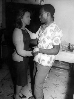 African man and English woman on the dance floor at a party African man and English woman on the dance floor at a party