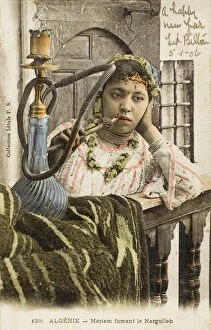 Related Images Collection: Algeria - Woman smoking a nargile pipe