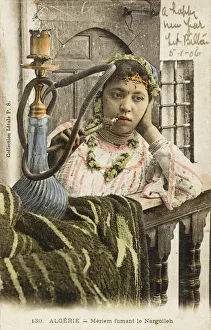 Algeria - Woman smoking a nargile pipe Algeria - Woman smoking a nargile pipe