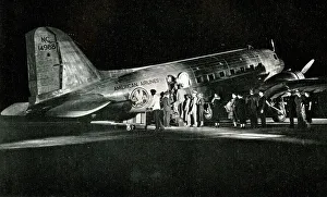 American Airlines passengers boarding a night flight American Airlines passengers boarding a night flight