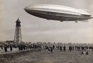 Prints of R-100 Airship Flying Close to the Docking Tower at Cardington, Bedfordshire Date: 1930 Aviation Prints: R-100 Airship at Cardington Docking Tower Print, 1930