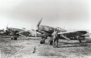 Prints of Engineers Standing with a Row of Three Luftwaffe Messerschmitt Bf-109G-6R2 Parked Behind with Rocket Launchers Fitted under the Wing Date: 1940s Airplanes And Aviation Prints: Messerschmitt Bf-109G-6R2 Engineers with Aircraft Print