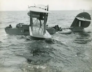 Prints of A Search and Rescue Supermarine Walrus Picking Up a Downed and Stranded Pilot in a Rubber Life-Raft Dinghy in the Sea Date: 1940s Airplanes And Aviation Prints: Supermarine Walrus Search and Rescue Print 1940s