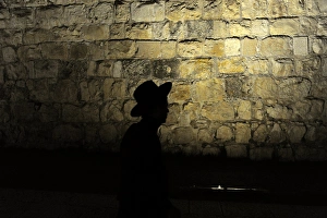 Backlit view of the silhouette of a an orthodox Jew. Old Cit Backlit view of the silhouette of a an orthodox Jew. Old Cit