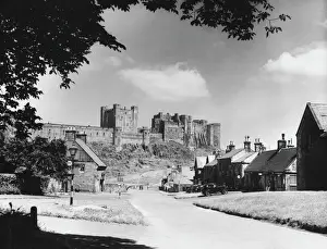 Prints of Bamburgh Castle, perched on a basalt outcrop on the edge of the North Sea at Bamburgh, Northumberland, it played a great part in the Border Wars (with Scotland) Castle Ruin Prints: Bamburgh Castle Print: North Sea Coastline View