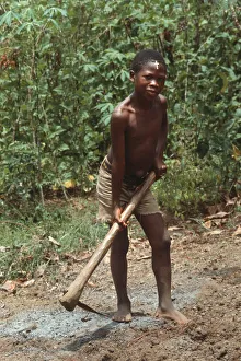 Barefoot boy with mattock, Sierra Leone Barefoot boy with mattock, Sierra Leone