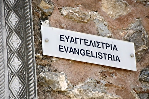 Bilingual poster on the wall of the Church of Evangelistria Bilingual poster on the wall of the Church of Evangelistria