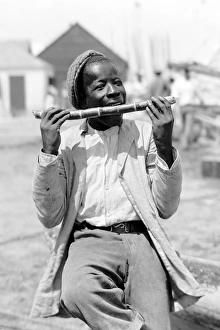 Black boy eating a stick of sugar cane in Nassau in the Baha Black boy eating a stick of sugar cane in Nassau in the Baha