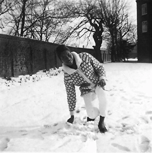 Black teenage girl touching and kneeling in the snow in Nott Black teenage girl touching and kneeling in the snow in Nott