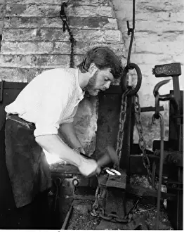 West Midlands Industry Prints: Blacksmith in his forge, working on a horseshoe