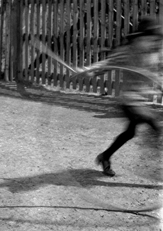 Blurred image of child with hoop and stick Blurred image of child with hoop and stick
