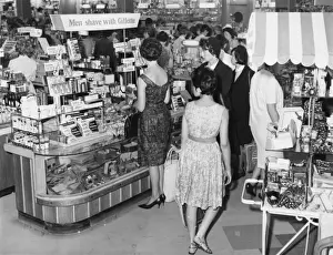 Print of Women Surrounding Men's Toiletries in Boots Exeter