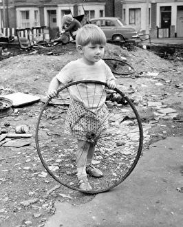 Boy with bicycle wheel, Balham, SW London Boy with bicycle wheel, Balham, SW London