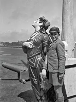 Boy in school uniform with figurehead at seaside Boy in school uniform with figurehead at seaside