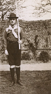 Boy in scout uniform in garden, Ealing, West London Boy in scout uniform in garden, Ealing, West London