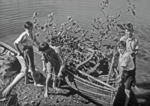 Boys with boat full of tree branches Boys with boat full of tree branches