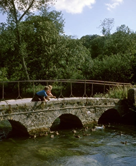 Two boys on a bridge, feeding ducks, Bibury, Gloucestershire Two boys on a bridge, feeding ducks, Bibury, Gloucestershire