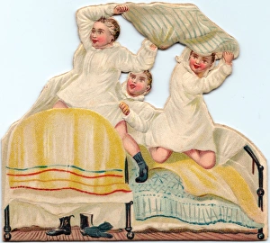 Three boys pillow fighting on a cutout greetings card Three boys pillow fighting on a cutout greetings card