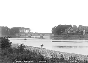 Prints of Bridge and Boathouse, Coleraine - a view of the Bridge and Boathouse on the river with two boys on the foreshore. (Location: Northern Ireland; County Antrim; Coleraine). Date: circa early 1900s County Londonderry Prints: Coleraine Bridge and Boathouse Print, circa early 1900s