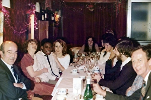 British Caribbean man at a Christmas office dinner party British Caribbean man at a Christmas office dinner party
