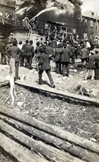 Canada - Ontario - Mining Town - Cobalt - Firefighters on shed roof fighting blaze Canada - Ontario - Mining Town - Cobalt - Firefighters on shed roof fighting blaze