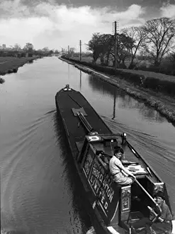 Prints of A young couple on a barge on a quiet stretch of the Shropshire Union Canal, near Chester, Cheshire, England. Date: 1950s Chester Prints: Canal Barge Couple Print, Shropshire Union Canal, 1950s