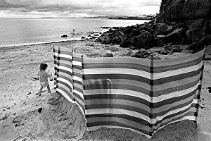 A child plays on Benllech beach, Anglesey north Wales A child plays on Benllech beach, Anglesey north Wales