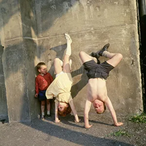 Children doing handstands on a Balham street, SW London Children doing handstands on a Balham street, SW London