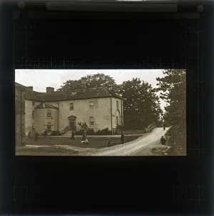 Children Playing outside a house on a village green Children Playing outside a house on a village green
