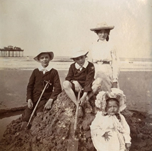 Four children on a sandcastle, Saltburn, North Yorkshire Four children on a sandcastle, Saltburn, North Yorkshire