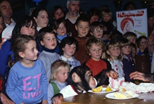 Children watching a chimps tea party Children watching a chimps tea party