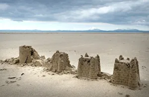 Childs abandoned sandcastles at low water on Harlech beach Childs abandoned sandcastles at low water on Harlech beach