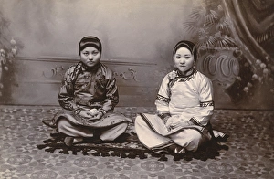 Two Chinese Girls seated on a small rug Two Chinese Girls seated on a small rug