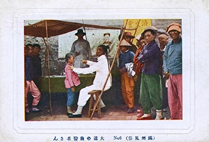 Chinese Street Doctor assessing a young patient Chinese Street Doctor assessing a young patient