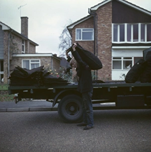 Coalman delivering coal in a street of houses Coalman delivering coal in a street of houses