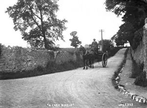 Prints of A Cork Jingle - a further back view of a man and horse and carriage on the road. (Location: Republic of Ireland; County Cork). Date: circa early 1900s Cork Prints: Early 20th Century Irish Print: A Cork Jingle