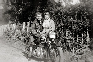 Couple with a 1938 Ariel Red Hunter motorcycle Couple with a 1938 Ariel Red Hunter motorcycle