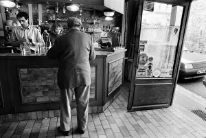 A customer is served in a bar in Luzarches, France A customer is served in a bar in Luzarches, France